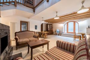 a living room with two couches and a fireplace at Agriturismo Al Gallo Nero Rosso in Tenno