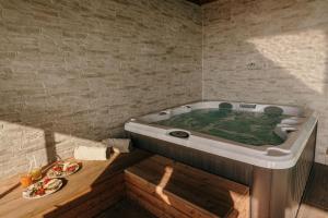 a jacuzzi tub in the corner of a room at Villa Di Sotto in Castelnuovo Berardenga