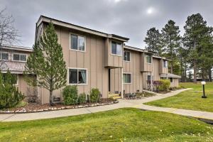 a row of apartment buildings with a yard at Pagosa Springs Townhome with Mountain Views! in Pagosa Springs