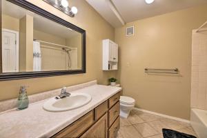 a bathroom with a sink and a toilet and a mirror at Pagosa Springs Townhome with Mountain Views! in Pagosa Springs +20 photos