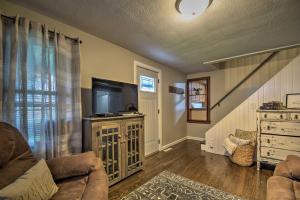 a living room with a couch and a flat screen tv at Cozy Goshen Farmhouse about 9 Mi to Amish Acres in Goshen