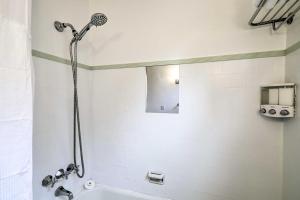 a bathroom with a shower and a tub at Updated Menlo Park Home Less Than 1 Mile to Stanford! in Menlo Park +18 photos