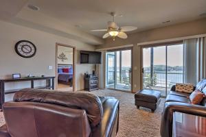 a living room with a couch and a table at Lake Ozark Condo with Boat Slip and Pool Access! in Lake Ozark