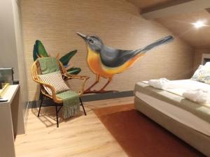 a bird perched on top of a bed in a room at 34 GuestHouse in Setúbal