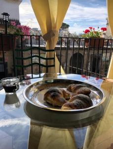 a plate of pastries on a table on a balcony at Palazzo Capece in Caivano