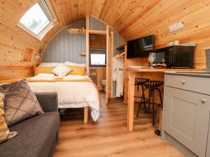 a bedroom with a bed and a desk in a room at Lapwing Lodge in Lancaster