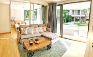 a living room with a couch and a coffee table at บ้านแสนคราม in Ban Huai Sai Tai