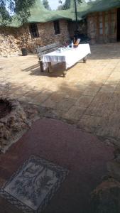 a table and a bench on a patio at casa hobbit Puente Genil in Puente-Genil