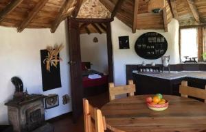 a dining room with a wooden table with a bowl of fruit at casa hobbit Puente Genil in Puente Genil