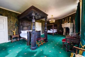 a bedroom with a large bed and a fireplace at Appleby Castle in Appleby +126 photos