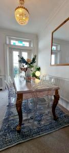a dining room with a table and chairs at Elegant 5 bed 4 bath 'Vogue House' Parisian style home in Margate