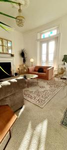 a living room with a couch and a fireplace at Elegant 5 bed 4 bath 'Vogue House' Parisian style home in Margate