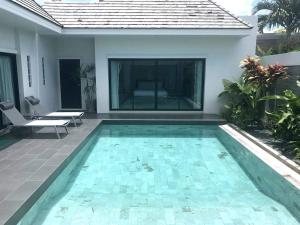 a swimming pool in the backyard of a villa at Villa Tara nr Layan Beach in Bang Tao Beach
