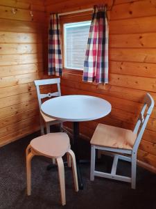 a room with a table and two chairs in a cabin at Höfn Cottages in Höfn