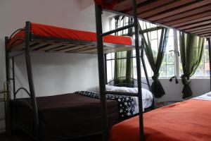Postel nebo postele na pokoji v ubytování Hostal Cafe San Bernabe