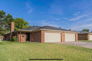 a home with a brick house with a garage at Large open space for family fun! in Amarillo