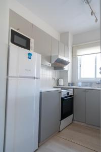 a kitchen with white appliances and a white refrigerator at Kypkeys Apartments in Voroklini
