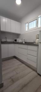 a kitchen with white cabinets and a counter top at Apartamentos Europa - Playa del Inglés - Yumbo in San Bartolomé