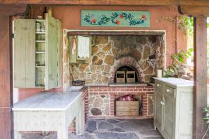 a kitchen with a brick oven in a stone wall at Zacharoulas Katikies in Amarynthos