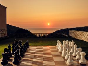 a chess board with the sunset in the background at Karousa Villa - A luxury retreat with stunning views, by Zantewize in Anafonítria