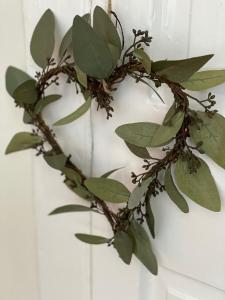 a wreath with green leaves on a white wall at The Bakehouse in Kelso
