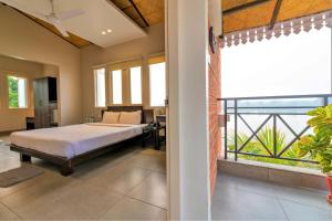 a bedroom with a bed and a balcony at Jalchhabi Hotel & Resort in Lālbāgh
