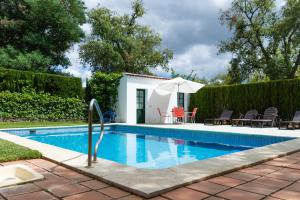 a villa with a swimming pool in a yard at Casa Rural La Gallega in Aracena
