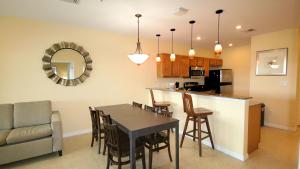 a kitchen and living room with a table and a bar at John's Pass Hotel - Fully Remote Check In in St. Pete Beach