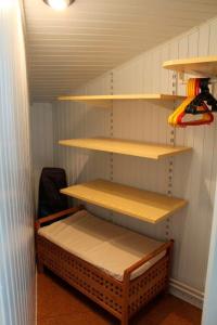 a closet with shelves and a bed in it at Ferienwohnung Carstensen Nr2 in Fehmarn