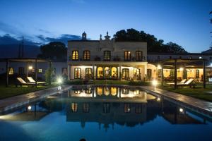 a large house with a swimming pool at night at Patios De Cafayate in Cafayate
