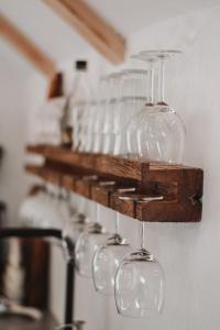 a row of wine glasses hanging on a wall at Zidanica Žagar in Dolenjske Toplice