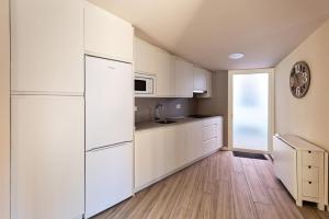 a kitchen with white appliances and a wooden floor at A TU VERA VUT-09/298 in Burgos