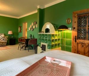 a green bedroom with a bed and a dining room at Jules&Jim Gästehaus in Linz