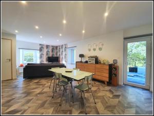 a living room with a table and chairs and a couch at LE RETRO in Éloyes