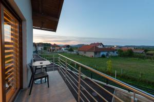 a balcony with a desk and a view of a field at Sobe Mili Ozren in Doboj