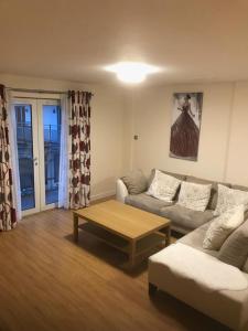 a living room with a couch and a coffee table at ochiltree apartment in Glasgow