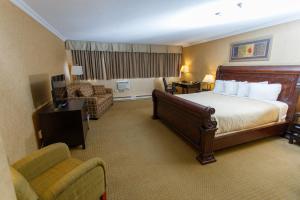 Un pat sau paturi într-o cameră la The George Dawson Inn & Conference Centre