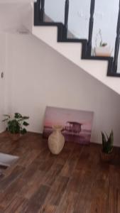 a room with a staircase with a table and potted plants at Casa en la playa in Tijuana