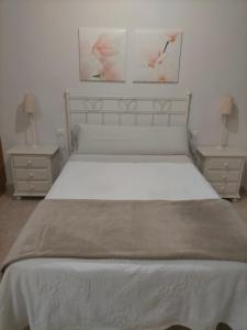 A bed or beds in a room at Castella Aquae estudio