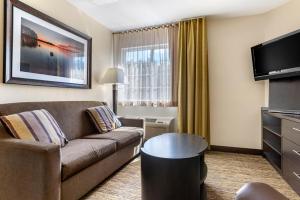 a living room with a couch and a tv at Candlewood Suites Alabaster, an IHG Hotel in Alabaster