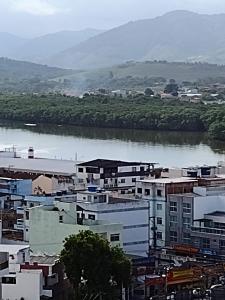 a view of a city with a river and buildings at Loft encantador centro Guarapari in Guarapari