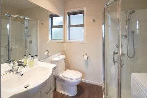 a bathroom with a toilet and a sink and a shower at Little Rock in Lake Tekapo