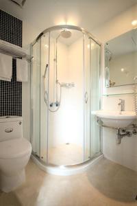 a bathroom with a shower and a toilet and a sink at Ximen Hotel in Taipei