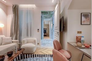a living room with a couch and chairs and a table at Quartier Libre - Saint Georges in Paris