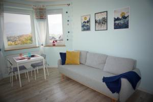 a living room with a couch and a table at Apartament Kolorowy in Szklarska Poręba