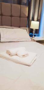 a bed with white sheets and a brown headboard at Mimi's Private Compact and Cozy Ensuite in Netherton