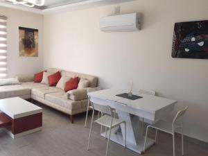 a living room with a white table and a couch at Fabulous 3 bedroom Apartment in Dalyan with pool in Dalyan