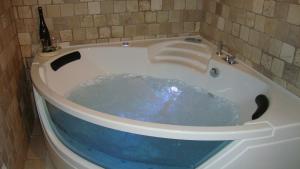 a bath tub with blue water inside of it at Fontana Vecchia B&B in Castellana Grotte