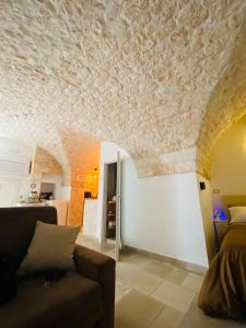 a living room with a couch and a stone ceiling at Dimora Le Volte Ostuni in Ostuni