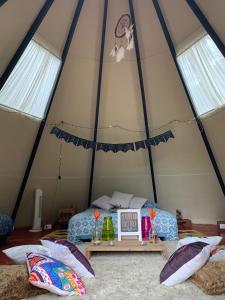 a bedroom in a tent with a bed and pillows at Refugio Natural Destino Payacal in La Mesa +49 photos